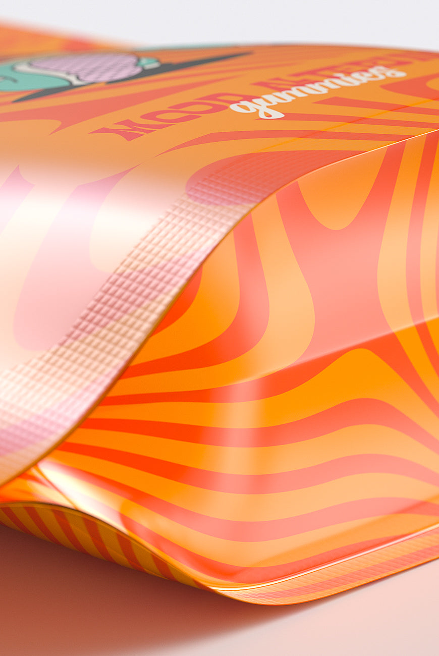 Flexible packaging film with vibrant orange and red swirl patterns, designed for wrapping or custom branding.