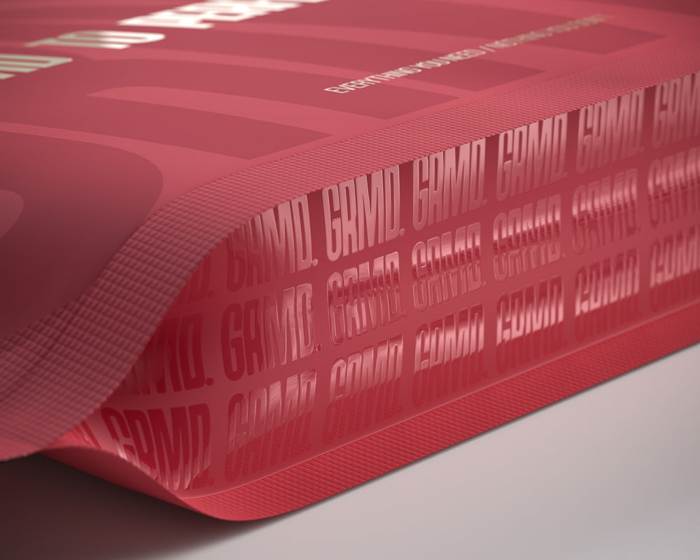 Tall cylindrical cardboard tubes with printed labels, designed for sustainable and stylish product packaging.