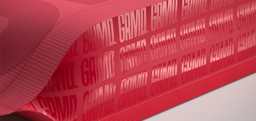 Red glossy packaging film with bold repeating branding text, showcasing a sleek and professional design.