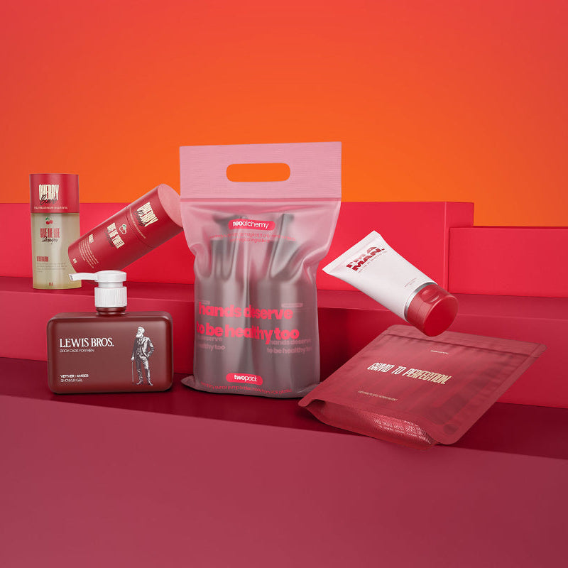 Grooming products including a bottle, packets, and a bag on a red and orange gradient background.
